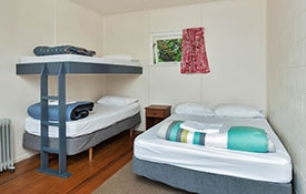 Standard Cabin bedroom with double bed and bunks